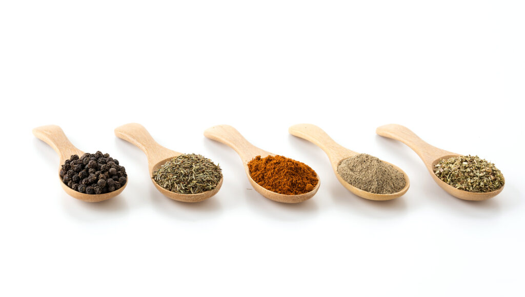 Wooden spoons filled with seasonings